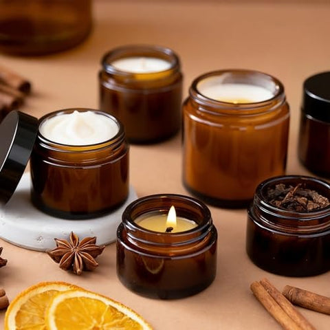 2 oz amber glass jars with black lids, one open showing cream inside
